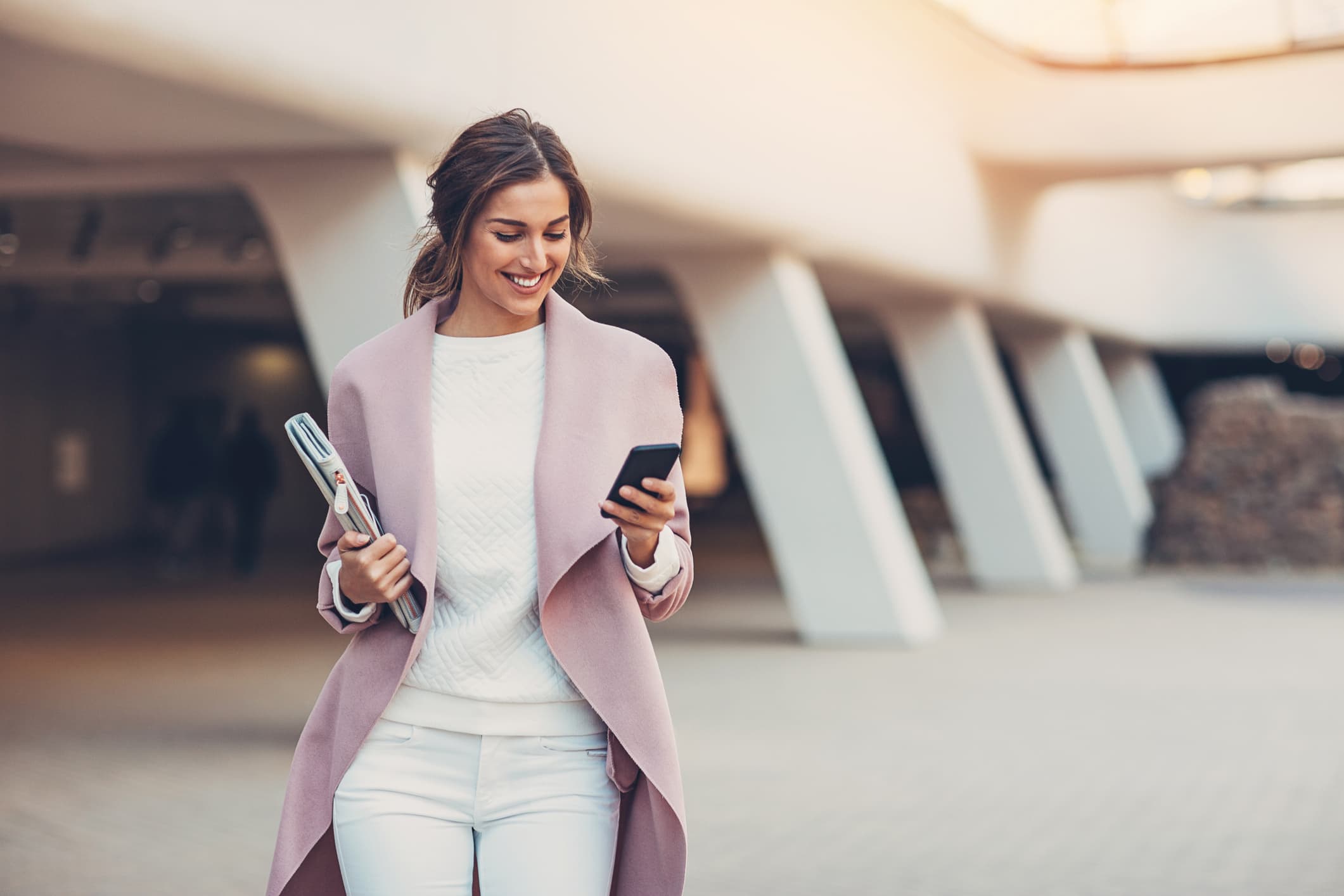 Woman smiling at her cell phone