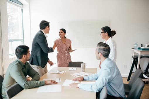 Buyers and sellers signing papers at a closing table