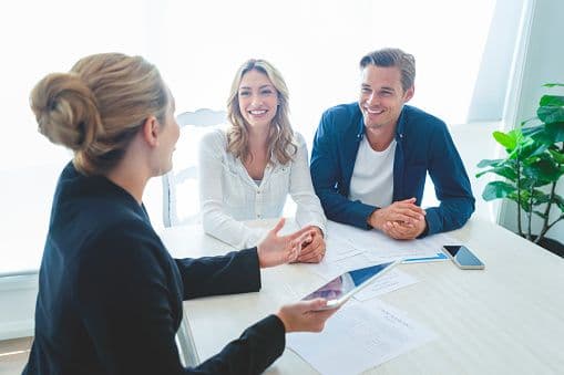 Couple reviewing closing documents at a table