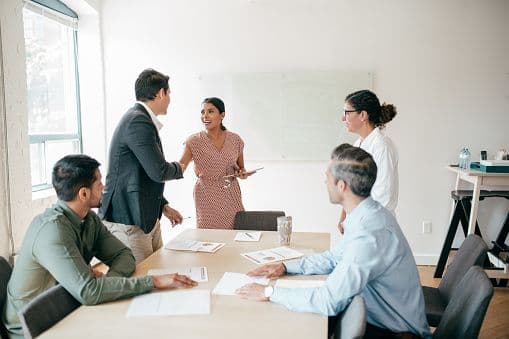 Buyers and sellers signing papers at a closing table