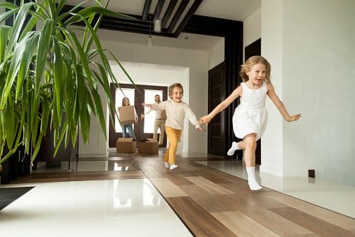 Children running into their new home on moving day
