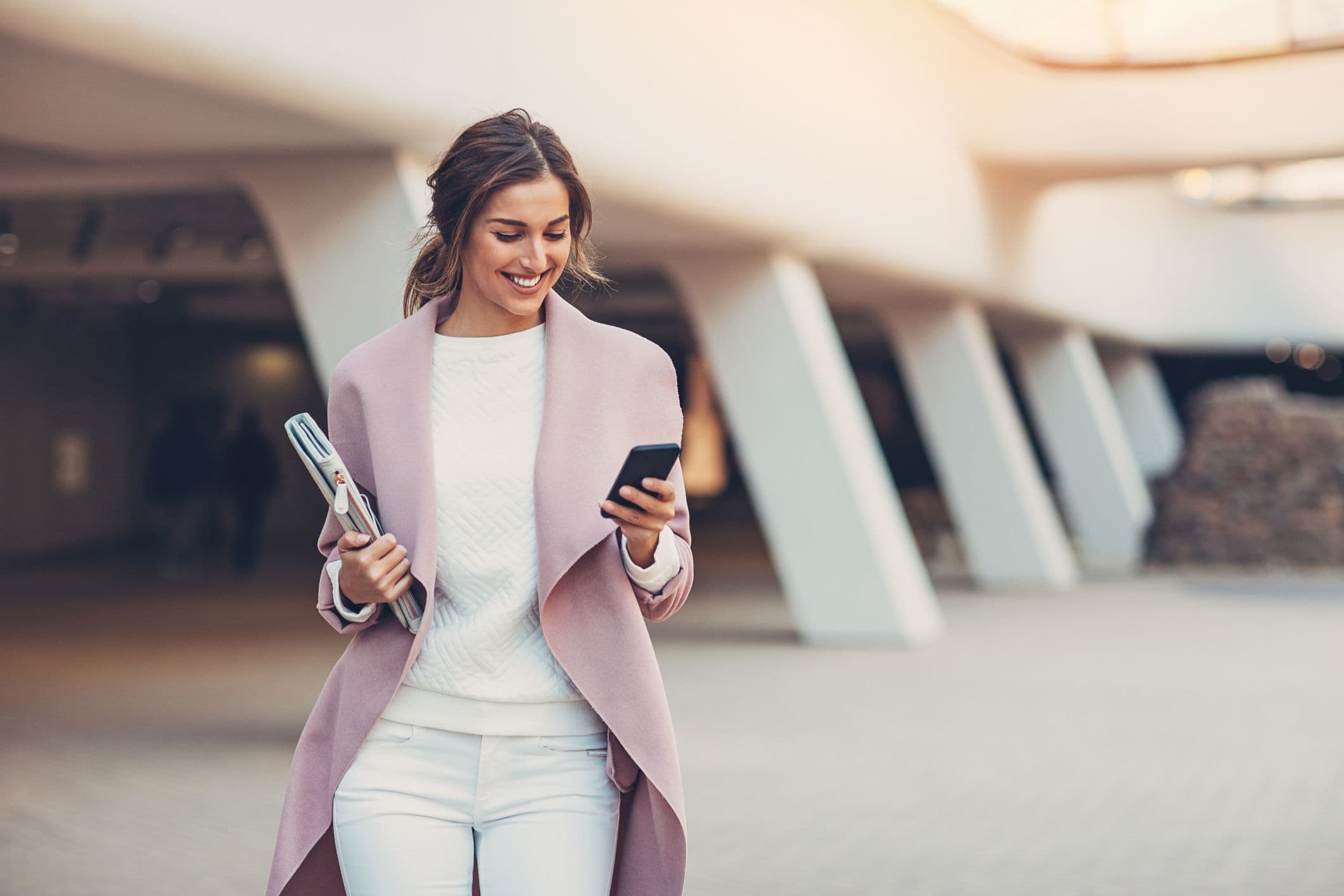 Woman smiling at her cell phone