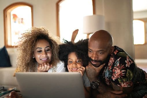 Family searching for homes on a laptop